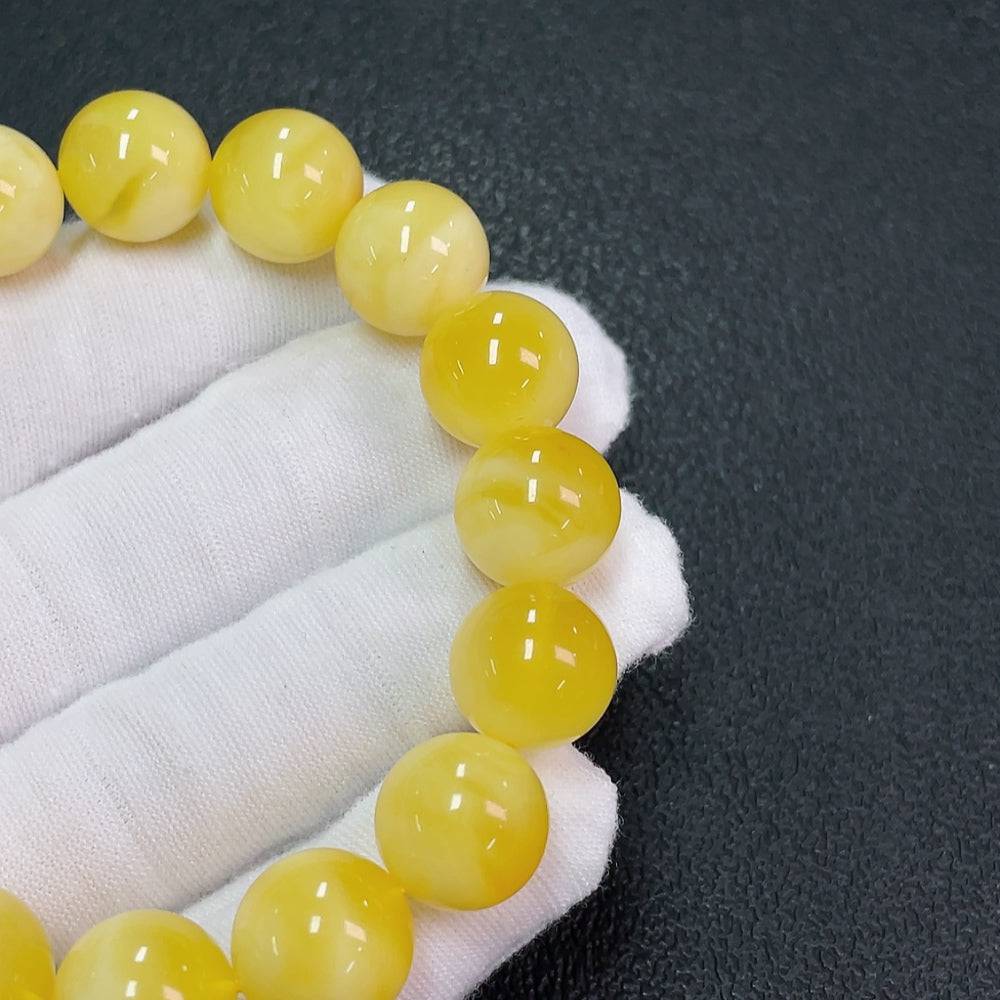 Huiliu Amber Beeswax Bracelet with 12.6mm beads, natural golden amber color, featuring a smooth, polished finish.