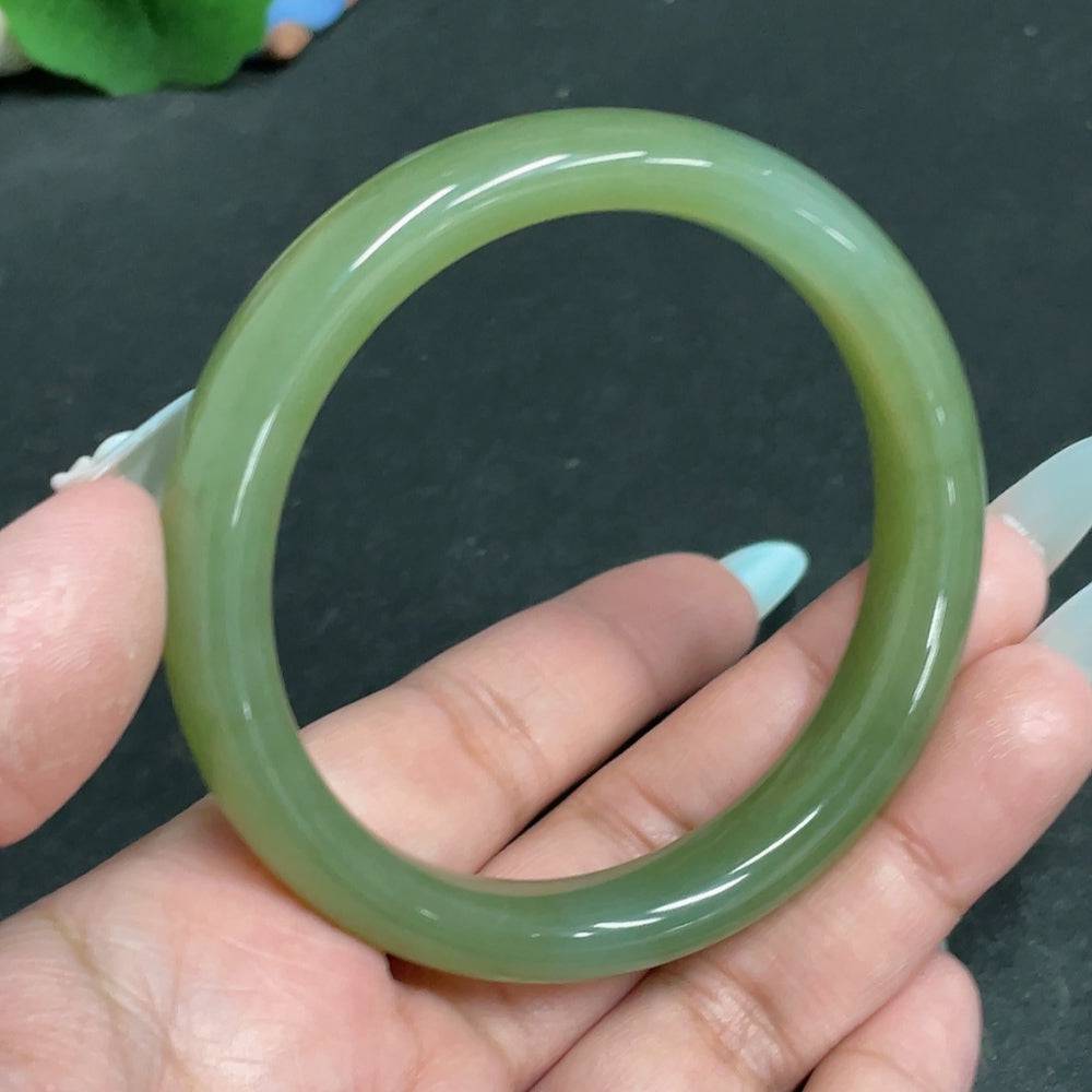 Huiliu certified Hetian jade round bracelet featuring smooth, polished green jade beads on an elastic band.