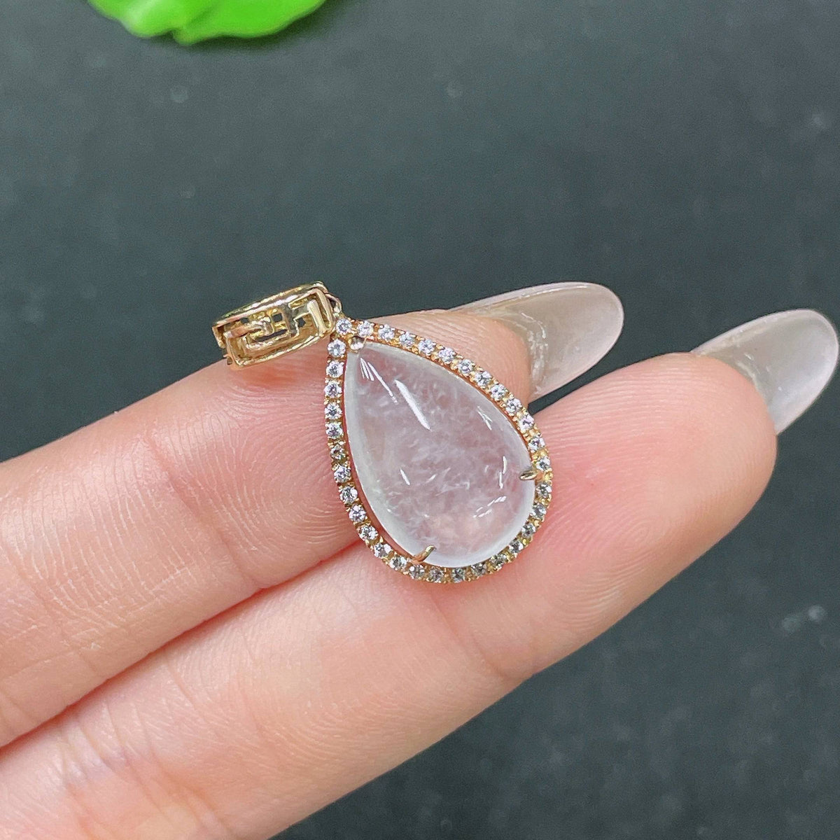 HUILIU HQ jadeite teardrop inlay pendant with smooth green jade, polished surface, and intricate inlay details.