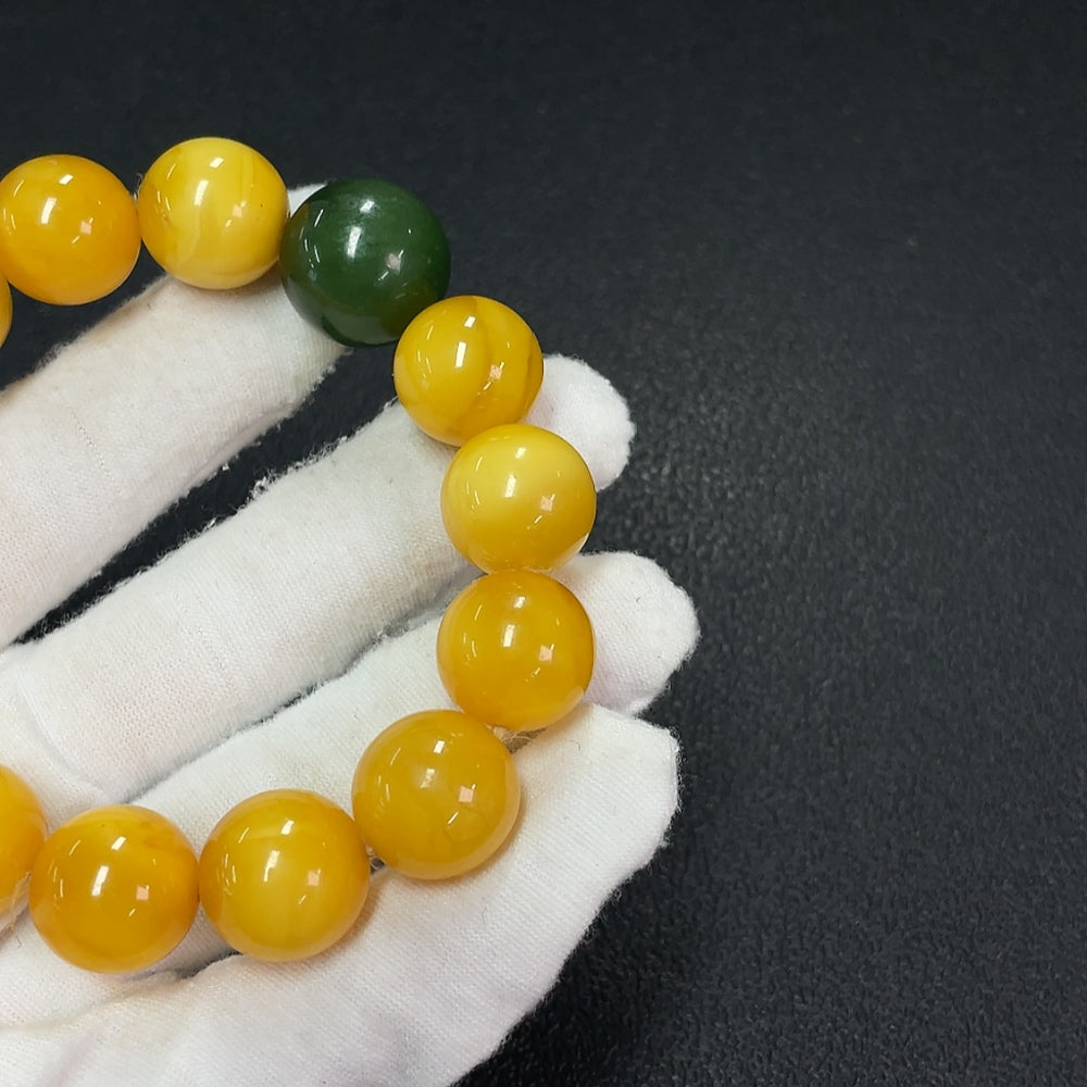 Amber beeswax bracelet with Hetian jade bead, partial repair, about 15mm, from HUILIU HQ, showcasing natural amber and jade materials.