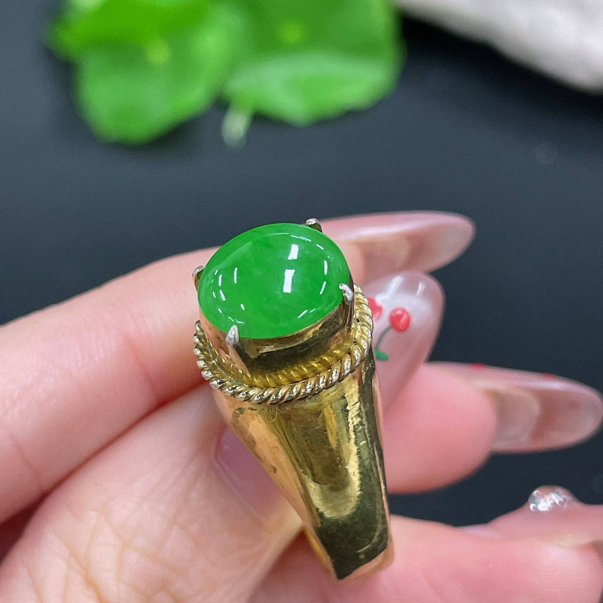 Jadeite cabochon from HUILIU HQ, weighing approximately 12.26g, showcasing smooth, polished jade with vibrant green color.