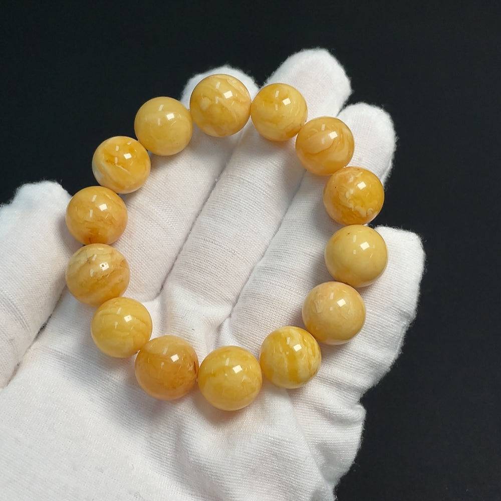 Amber beeswax bracelet from HUILIU HQ, 13.8mm beads, approximately 19.24g, showcasing natural amber's warm, golden hue.