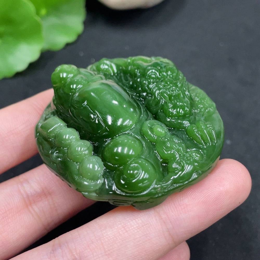 Huiliu certified Hetian jade pendant featuring a dragon motif, intricately carved and polished with a smooth finish.