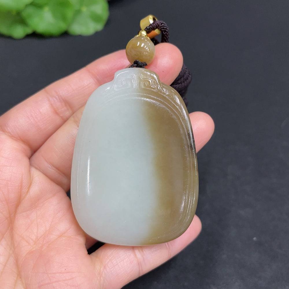 Huiliu certified Hetian jade pendant with smooth, plain design showcasing the rich green color of the jade stone.