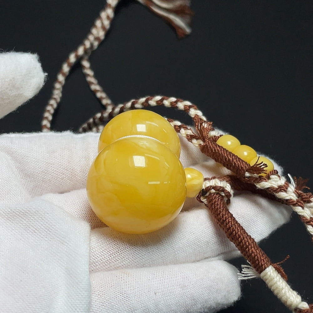 Amber Beeswax Pendant necklace from HKHQ featuring a warm, natural amber beeswax pendant on a delicate chain.