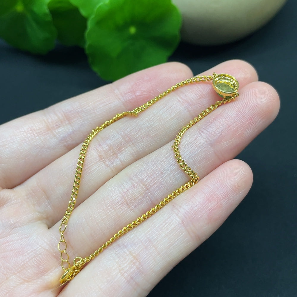 Jadeite cabochon bracelet by HKHQ featuring 18K gold band and diamond accents, showcasing a polished green gemstone design.