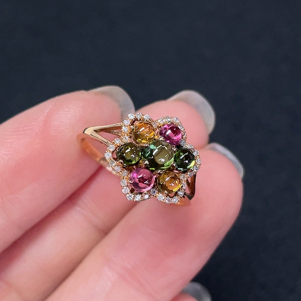 18K gold ring with inlaid tourmaline and diamond accents, elegant jewelry piece featuring colorful gemstone details.