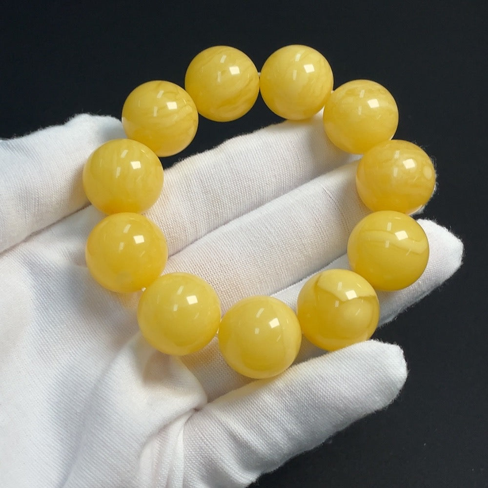 Amber beeswax gemstone bracelet with 17.5mm beads, approximately 34g, showcasing warm amber tones and natural gemstone texture.