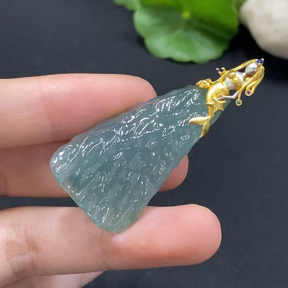 Huiliu certified jadeite pendant showcasing a smooth, polished green jade piece with natural stone variations and elegant craftsmanship.