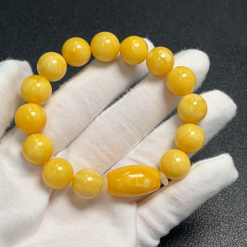 Huiliu Amber Beeswax bracelet with 11.5mm beads, natural amber color, featuring a smooth, rounded design and certified quality.