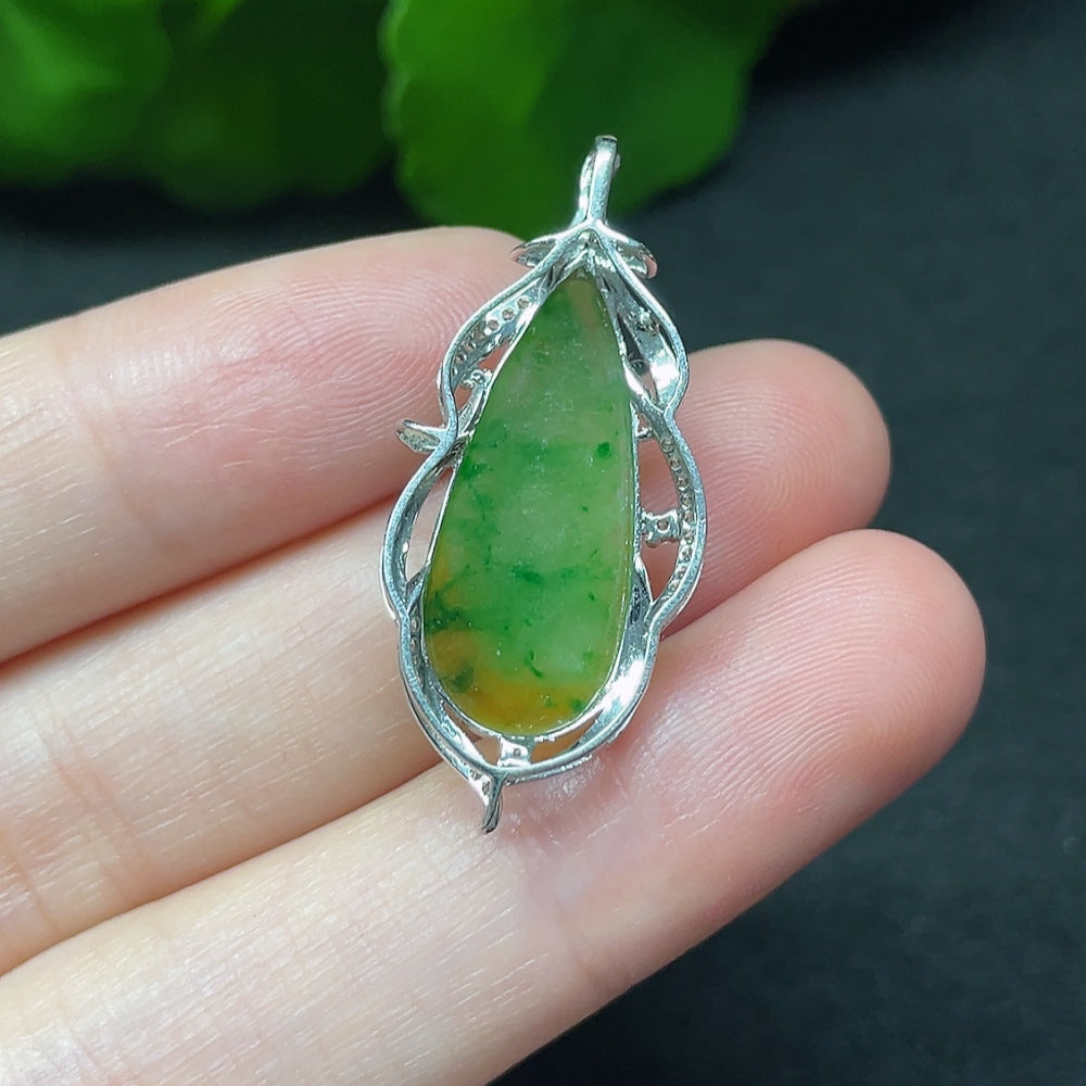Jadeite teardrop pendant with 18K gold and diamond accents, displayed on a necklace chain.