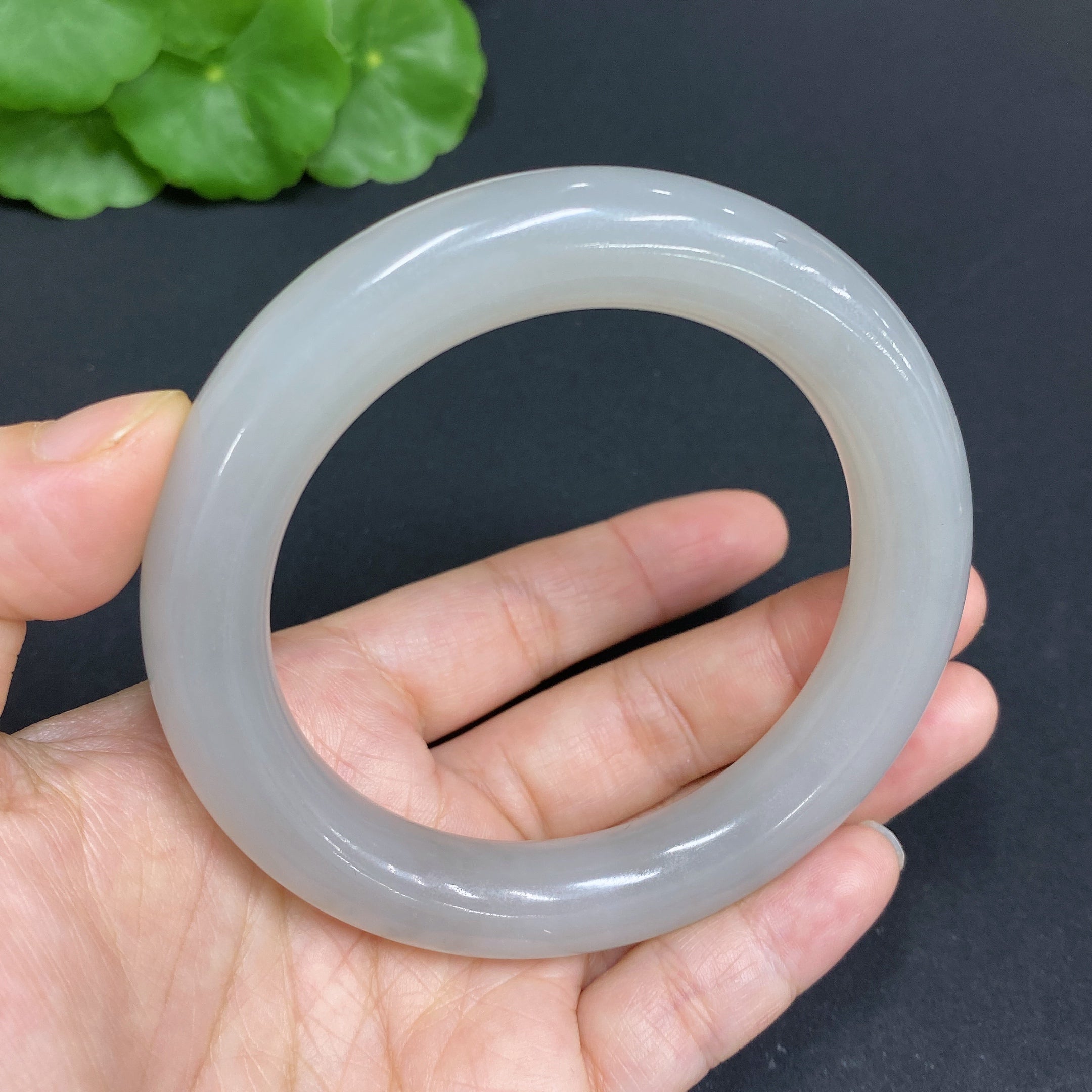 Huiliu certified Hetian jade round bangle with a smooth, polished surface and a rich green hue, size 58.3 mm.