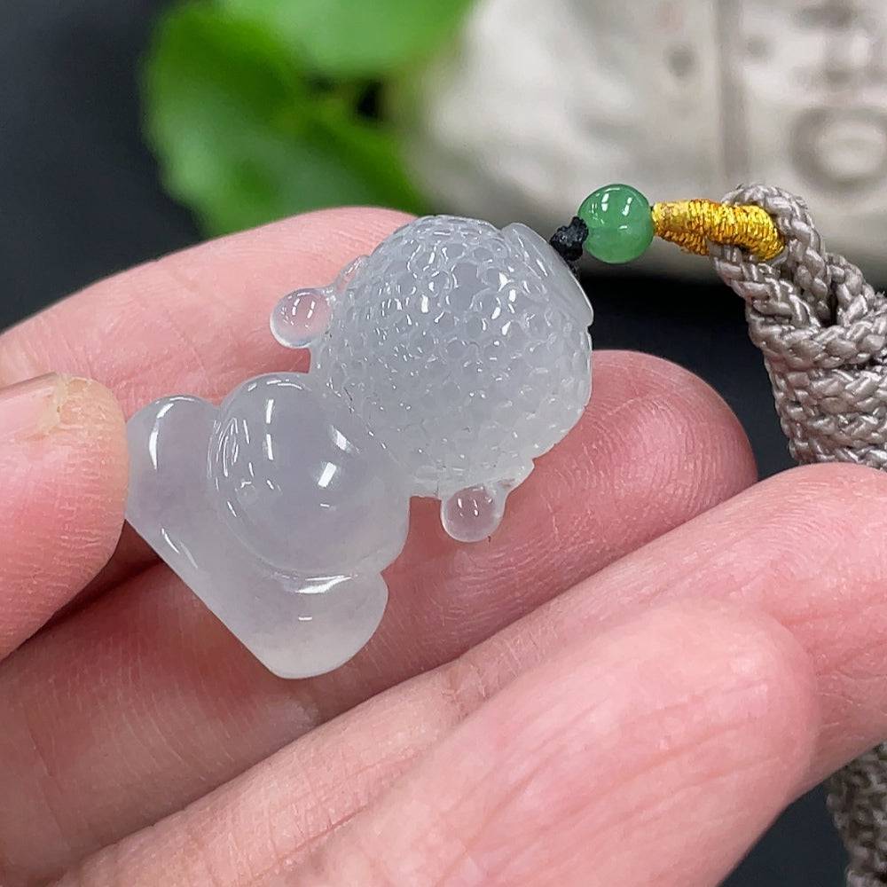 Jadeite Baby Buddha pendant in green jade, crafted by HUILIU HQ, featuring a detailed carved Buddha figure on a smooth jade surface.