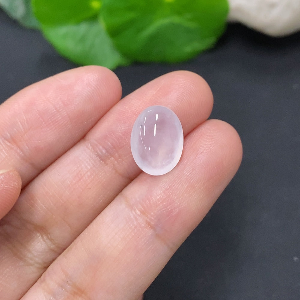 Handcrafted jadeite cabochon jewelry piece from HKHQ, showcasing a smooth, polished green gemstone with subtle natural patterns.