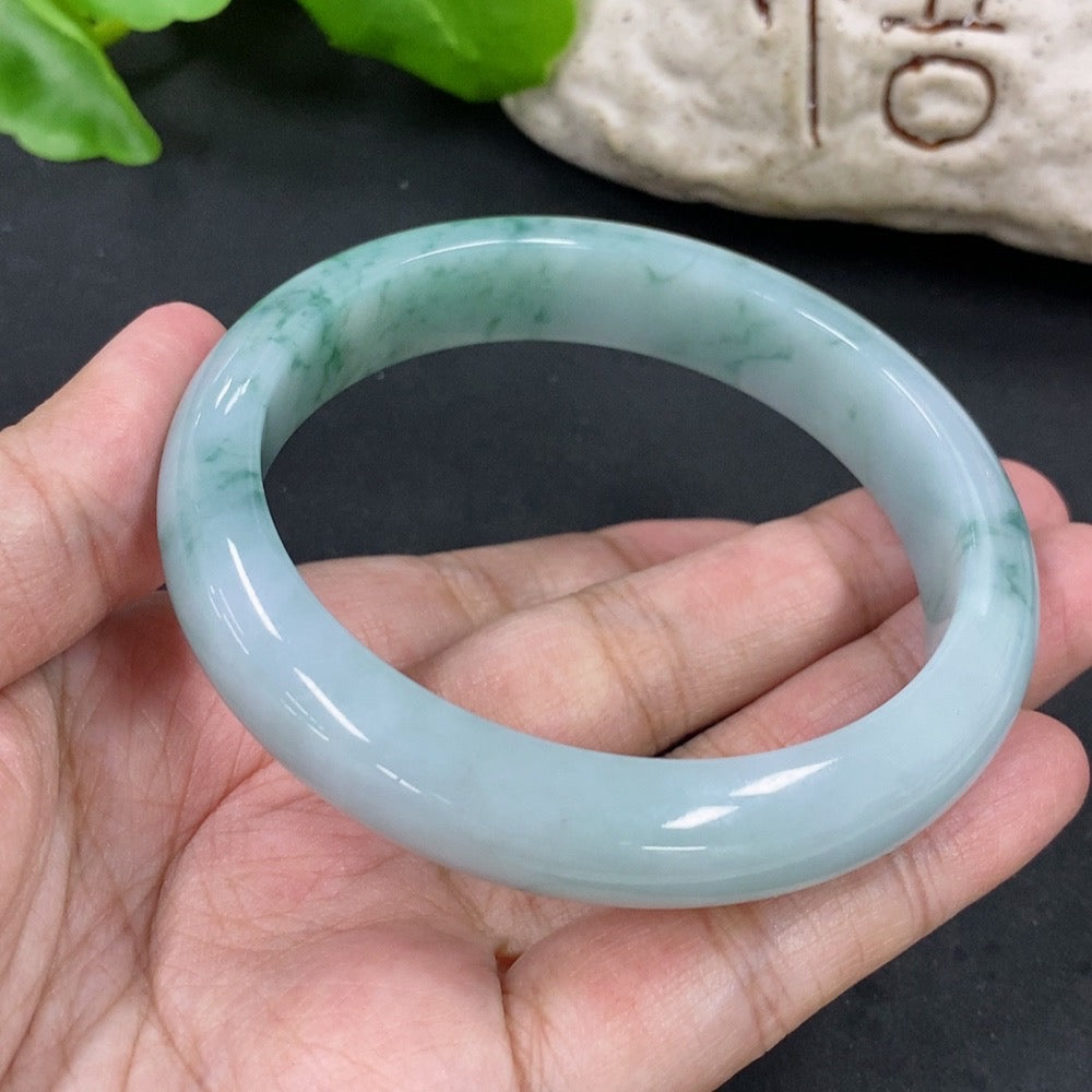 Jadeite round bangle with a 59.2mm diameter, crafted by HKHQ, weighing approximately 57.62g, showcasing smooth, polished jade surface.