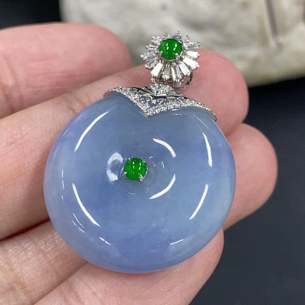 Jadeite peace knot pendant with 18K gold clasp and diamond accents, showcasing intricate design and smooth jade surface.