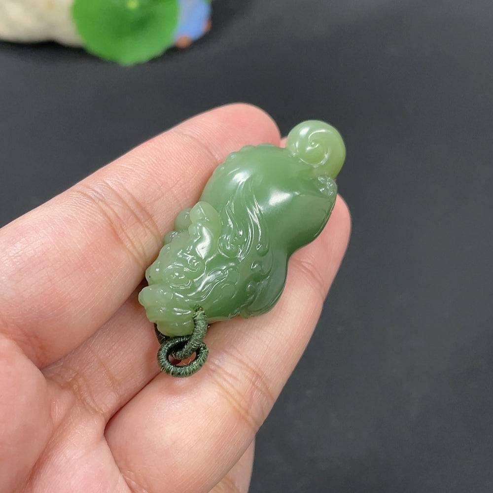 Huiliu certified Hetian jade pendant featuring an auspicious beast design, crafted from smooth, polished jade stone.