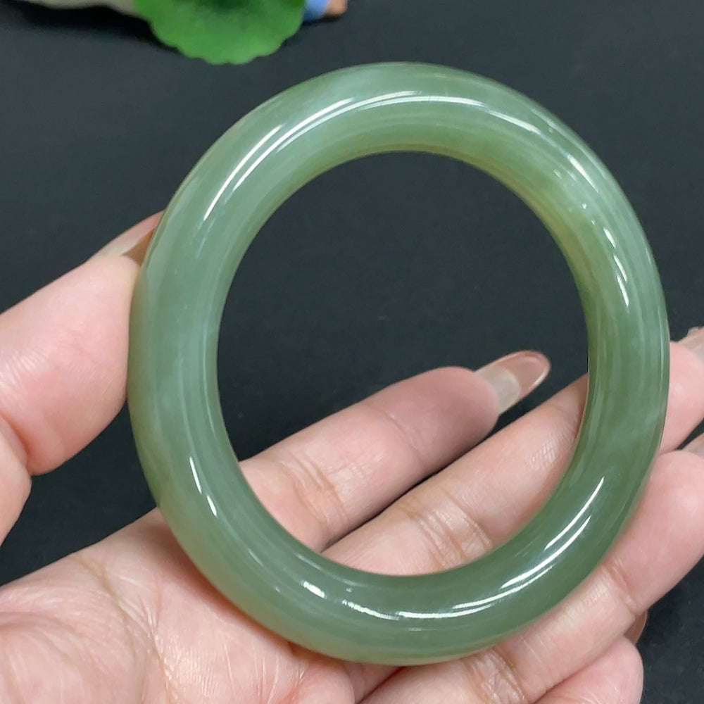 Hetian Jade round bangle from HUILIU HQ, size 56.7, weighing approximately 63.7g, featuring smooth, polished jade surface.