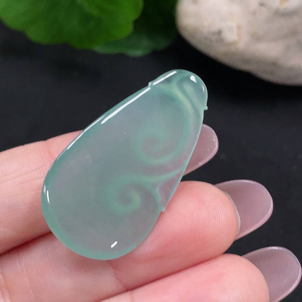 Jadeite Ruyi pendant from HUILIU HQ, crafted from green jade, showcasing smooth, polished surface and intricate Ruyi design.