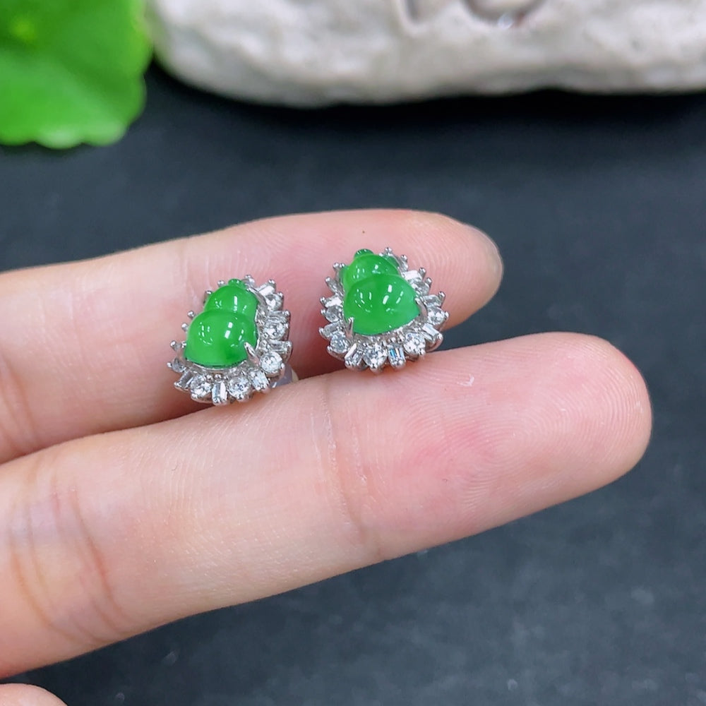 HKHQ jadeite earrings featuring smooth, polished green jade stones with silver hooks, showcasing elegant, natural gemstone jewelry.