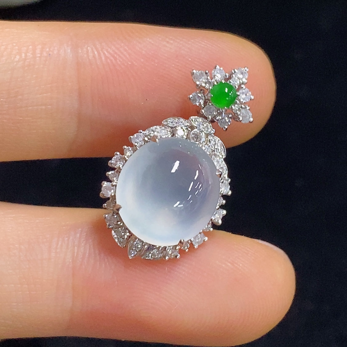 Jadeite pendant with 18K gold and diamond accents, showcasing a delicate necklace design on a neutral background.
