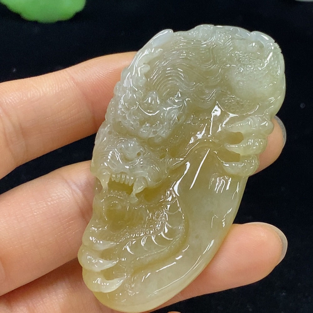 Jadeite dragon pendant weighing approximately 34.71g, featuring a detailed green jade design, on a neutral background.