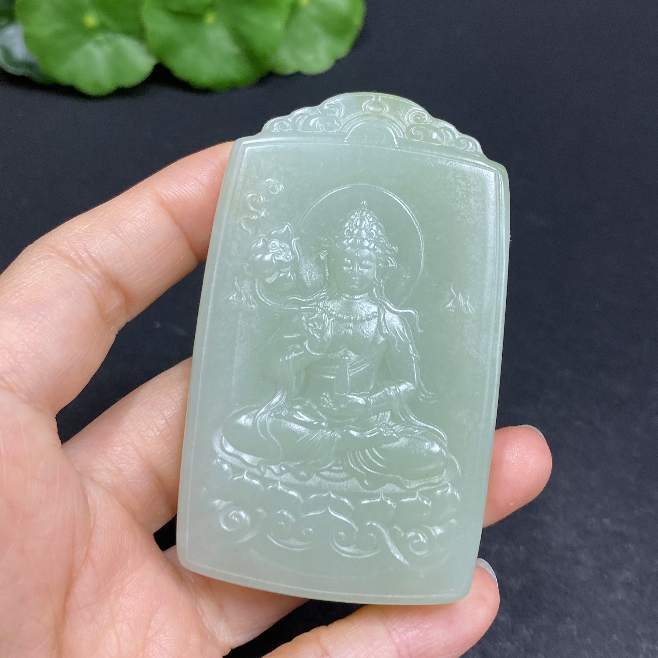Huiliu certified Hetian jade Guanyin pendant with intricate carving, showcasing smooth, polished jade craftsmanship.