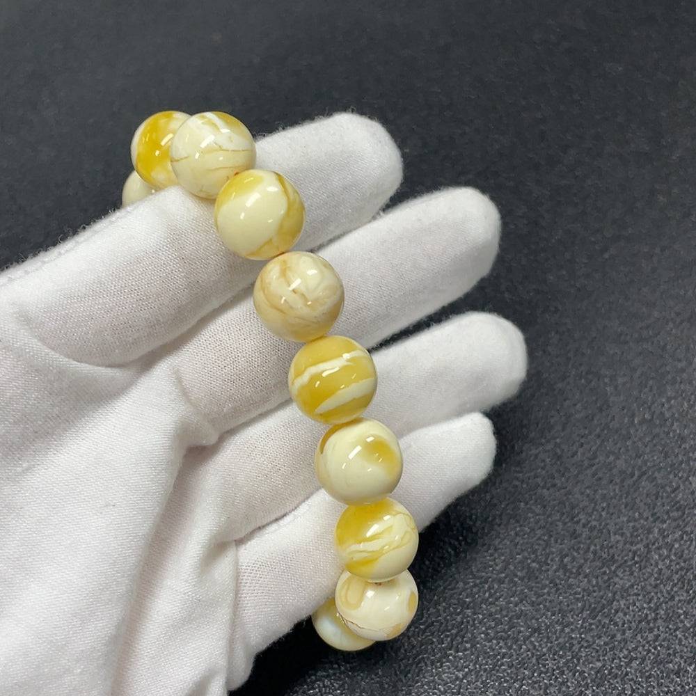 Huiliu Amber Beeswax Bracelet with 12.3mm amber beads, natural warm tones, and certified quality on a neutral background.