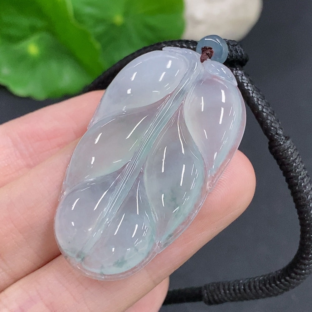 Jadeite leaf pendant necklace by HKHQ featuring a polished green jadeite leaf charm on a delicate chain.