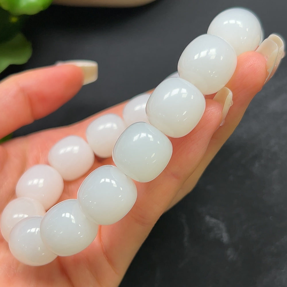 Hetian Jade bracelet by HKHQ featuring smooth, polished jade beads with a natural green hue and intricate craftsmanship.
