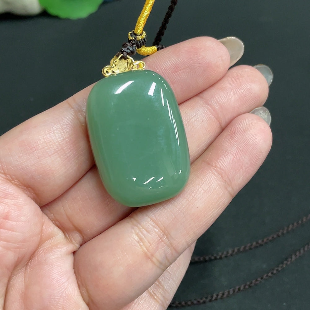 Huiliu certified Hetian jade pendant with plain design, 71% jade content, featuring a rope for wearing.