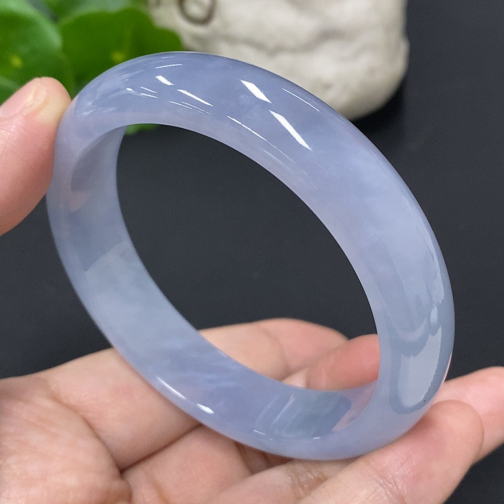 Jadeite round bangle with size 57.3, weighing approximately 56.3g, crafted by HUILIU HQ, showcasing smooth, polished jade surface.