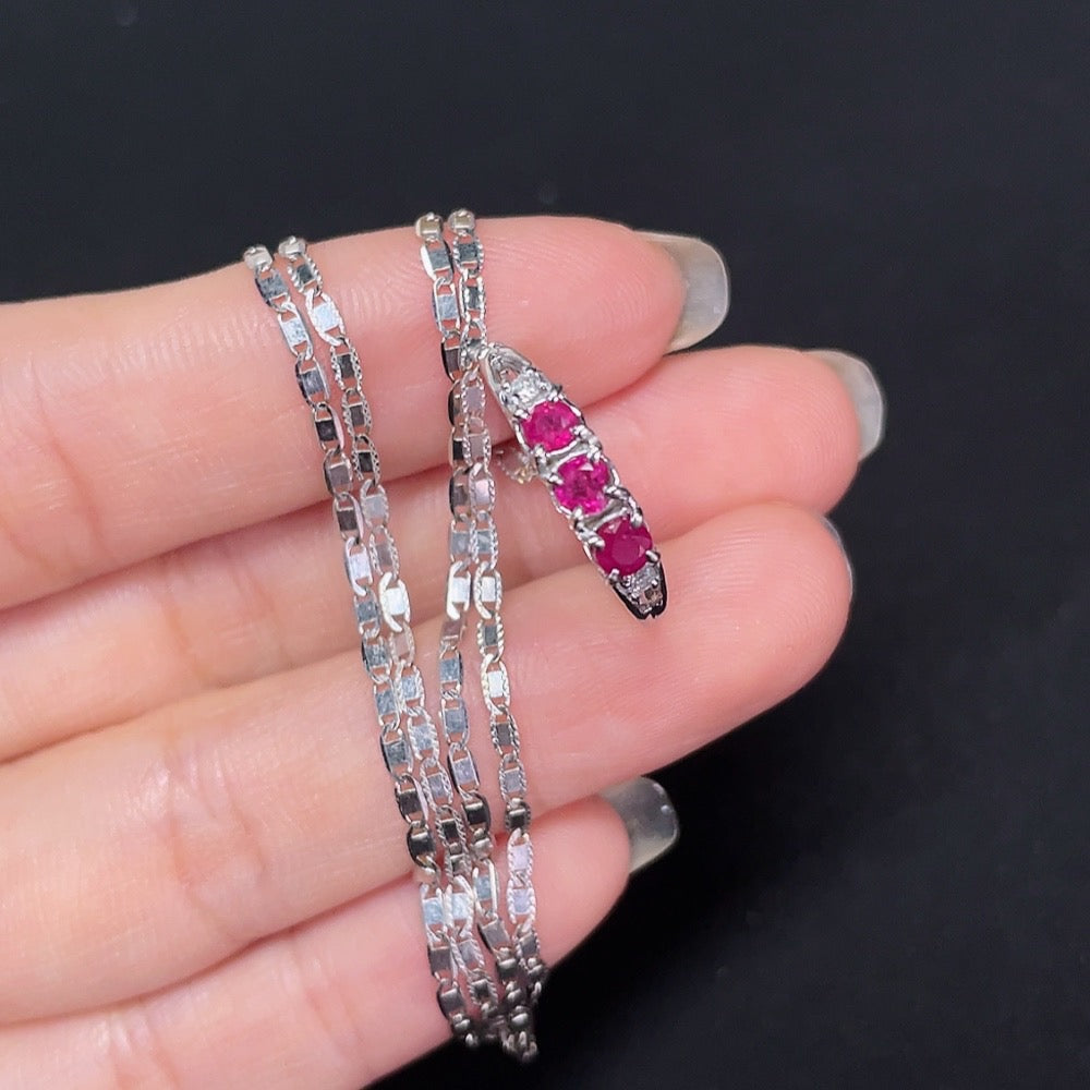 18k gold Ruby inlaid ring with diamond accents, size 13, featuring a detailed design and a chain, weighing approximately 4.69g.
