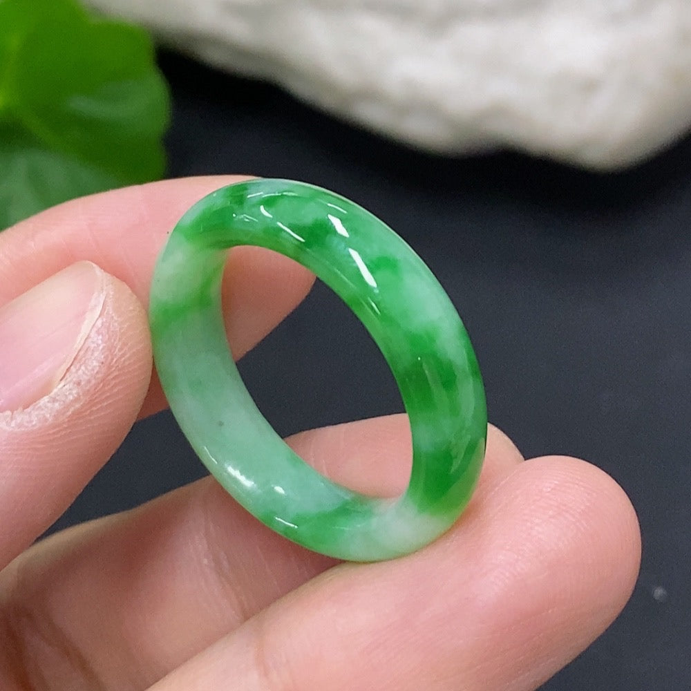 Close-up of a smooth jadeite ring from HKHQ featuring a polished, vibrant green jade stone set in a sleek band.