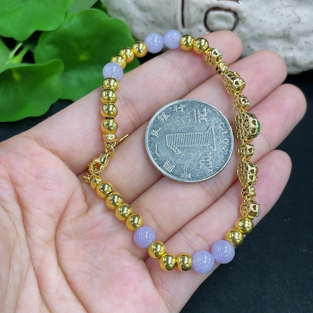 Jadeite bead bracelet with mixed gold accents, featuring polished jade beads and gold components, stylish jewelry accessory.