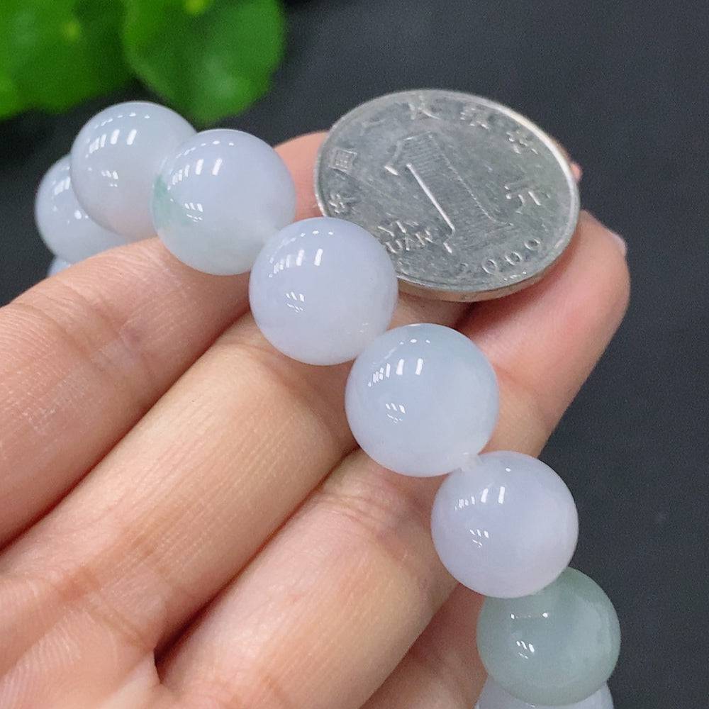 Huiliu Jadeite bracelet featuring 12.3mm smooth, polished jade stones on a delicate string, certified by Huiliu HQ.