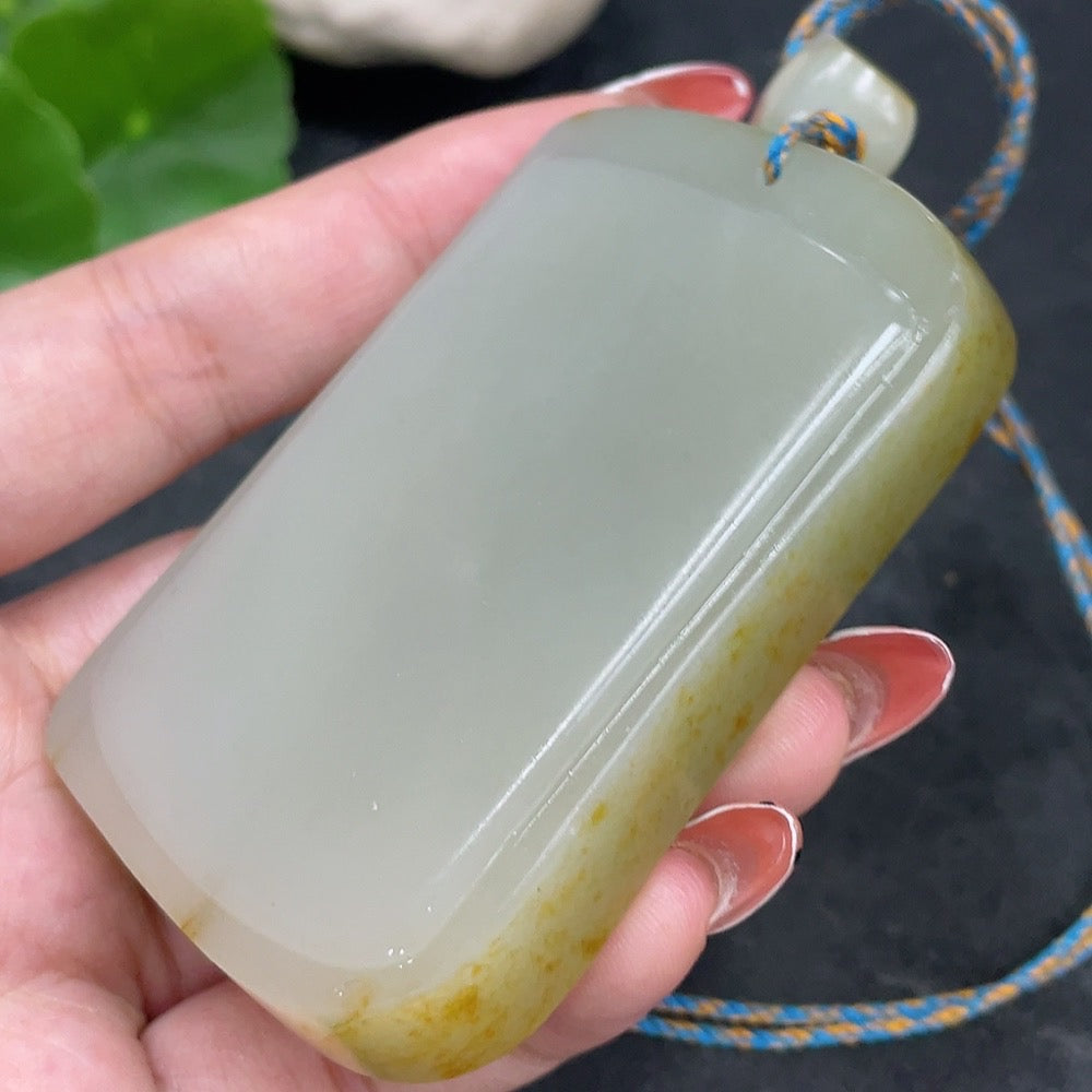 Huiliu certified Hetian jade seed pendant with plain design, undetermined skin color formation, includes string, natural stone appearance.