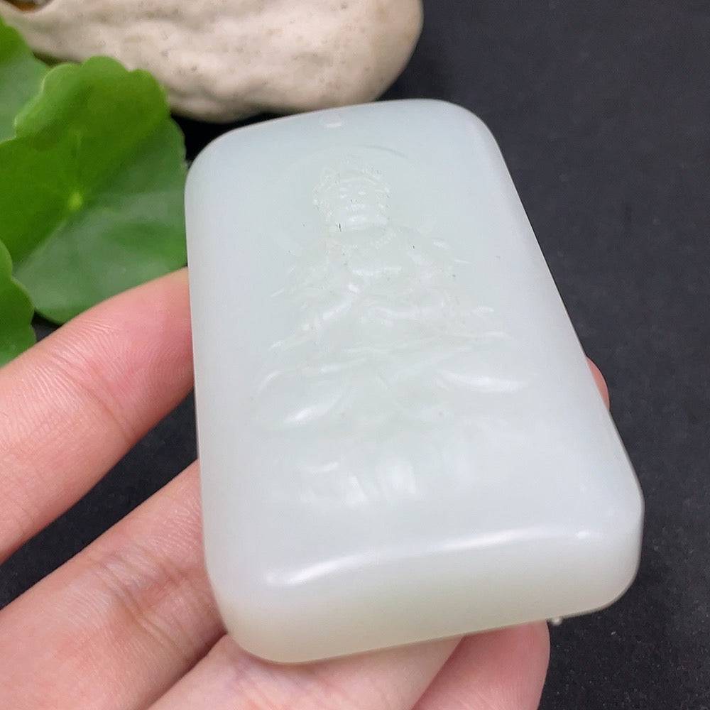 Huiliu certified Hetian jade pendant featuring Guanyin, intricately carved with smooth, polished jade surface and detailed figure.