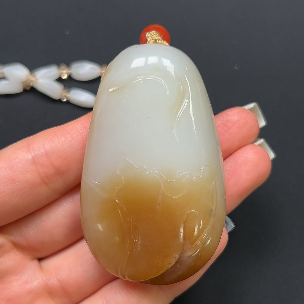 Hetian Jade "Joy on the Brow" pendant necklace with non-Hetian beads, featuring a polished jade pendant on a beaded chain.
