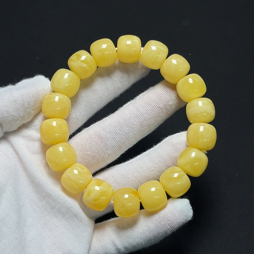 Amber beeswax bracelet from HKHQ, showcasing warm amber beads and natural craftsmanship on a neutral background.