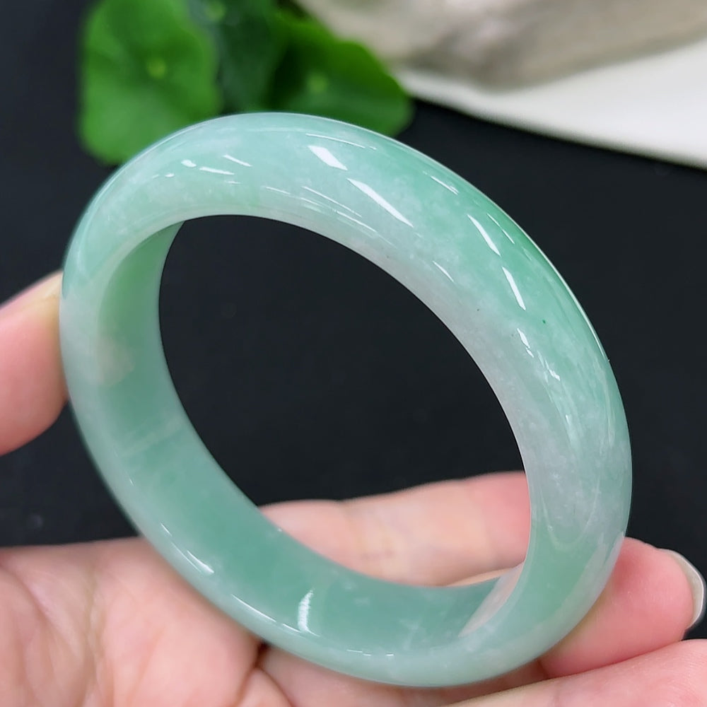 HKHQ jadeite round bangle, size 57.7, weighing approximately 66g, showcasing smooth, polished jadeite surface and elegant design.