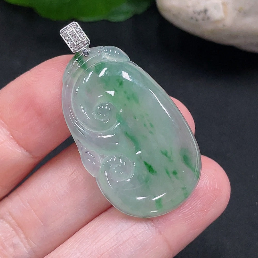 Jadeite Ruyi pendant with 18K gold and diamond accents, showcasing intricate craftsmanship and elegant design.