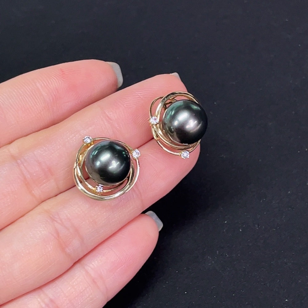 Saltwater pearl stud earrings in 14K gold by HKHQ, showcasing smooth, round pearls on a classic earring setting.