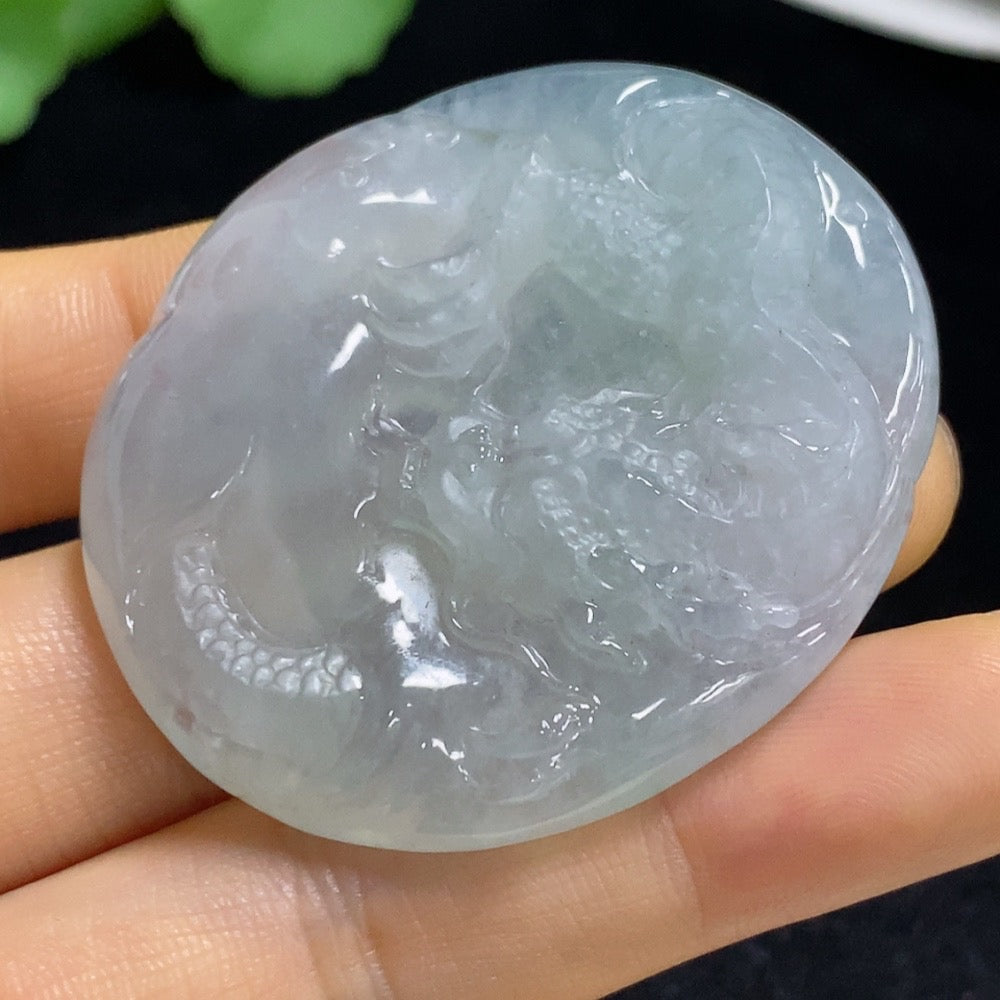 Jadeite pendant featuring a dragon design from HUILIU HQ, weighing approximately 33.56g, with intricate carved details.