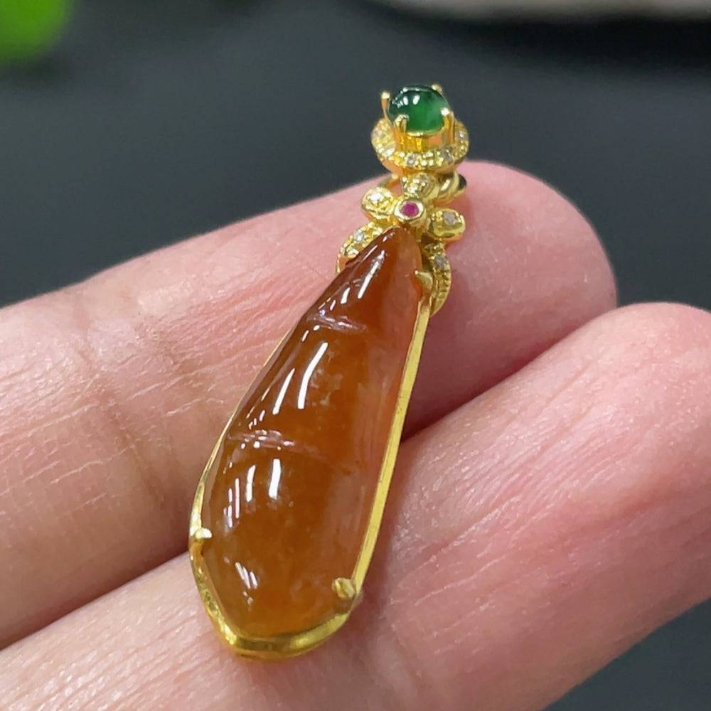 Jadeite auspicious bean pendant by HUILIU HQ with 18K gold and diamond inlay, showcasing detailed craftsmanship and smooth jade surface.