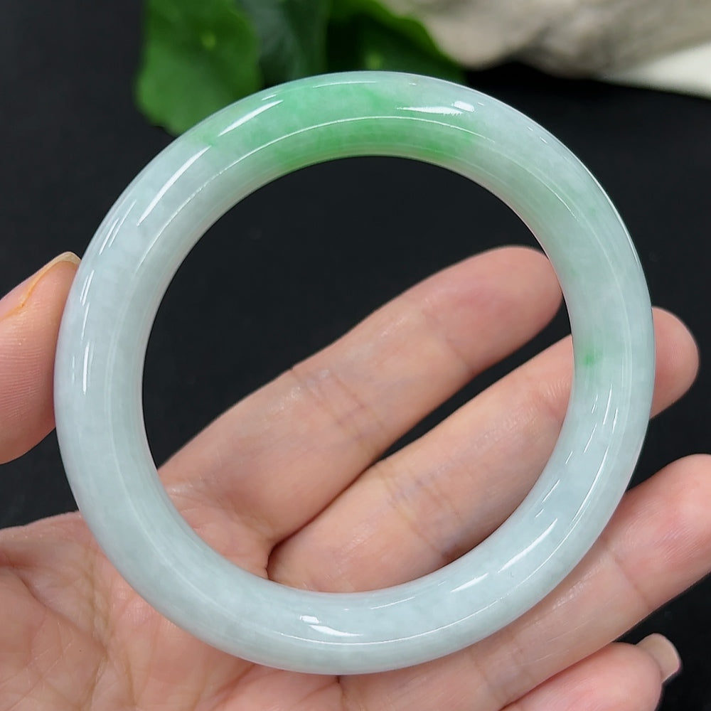 HKHQ jadeite round bangle in size 55, showcasing smooth, polished green jadeite with a sleek circular design.