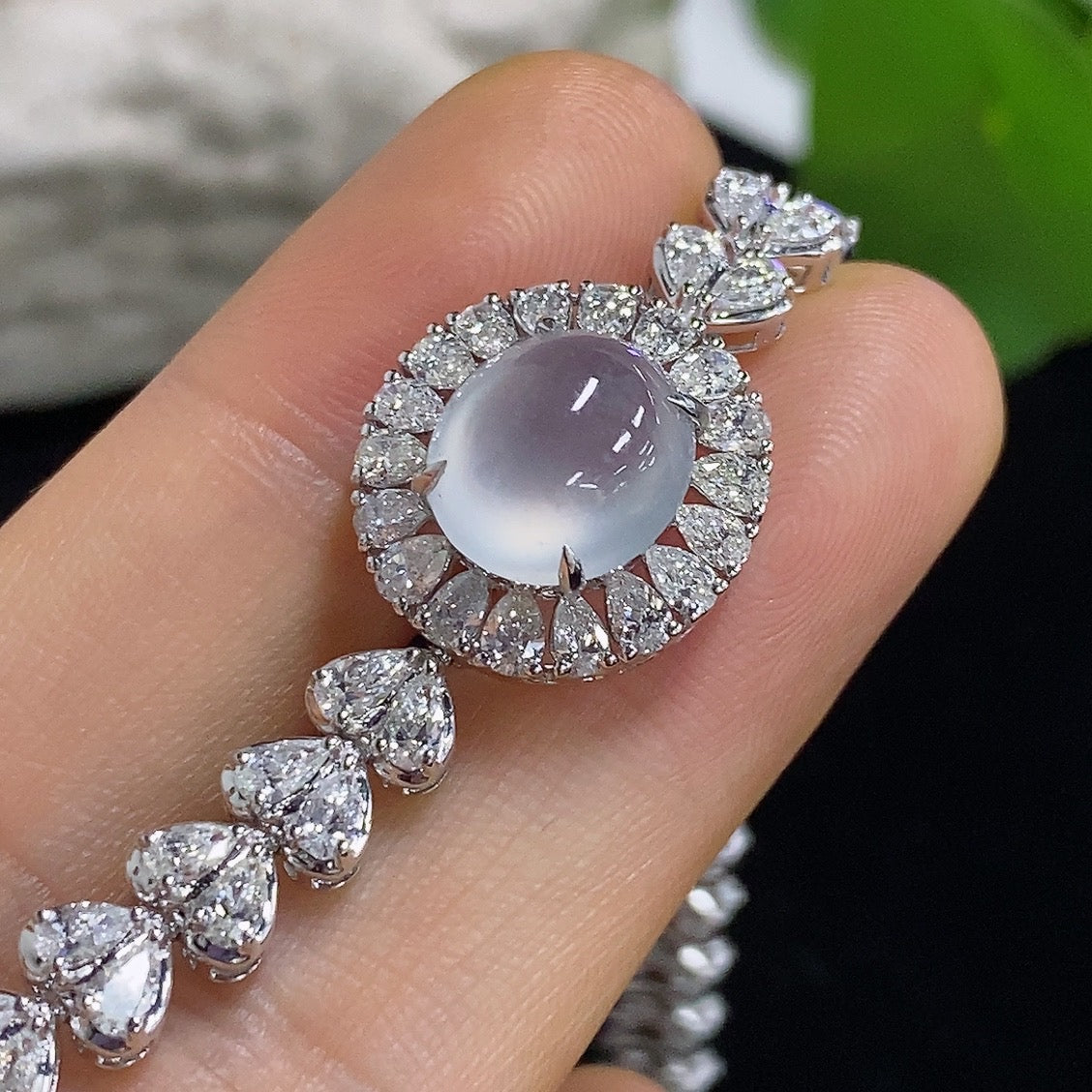 Jadeite cabochon bracelet with 18K gold and diamond accents from HKHQ, showcasing a polished jadeite stone and elegant gold setting.