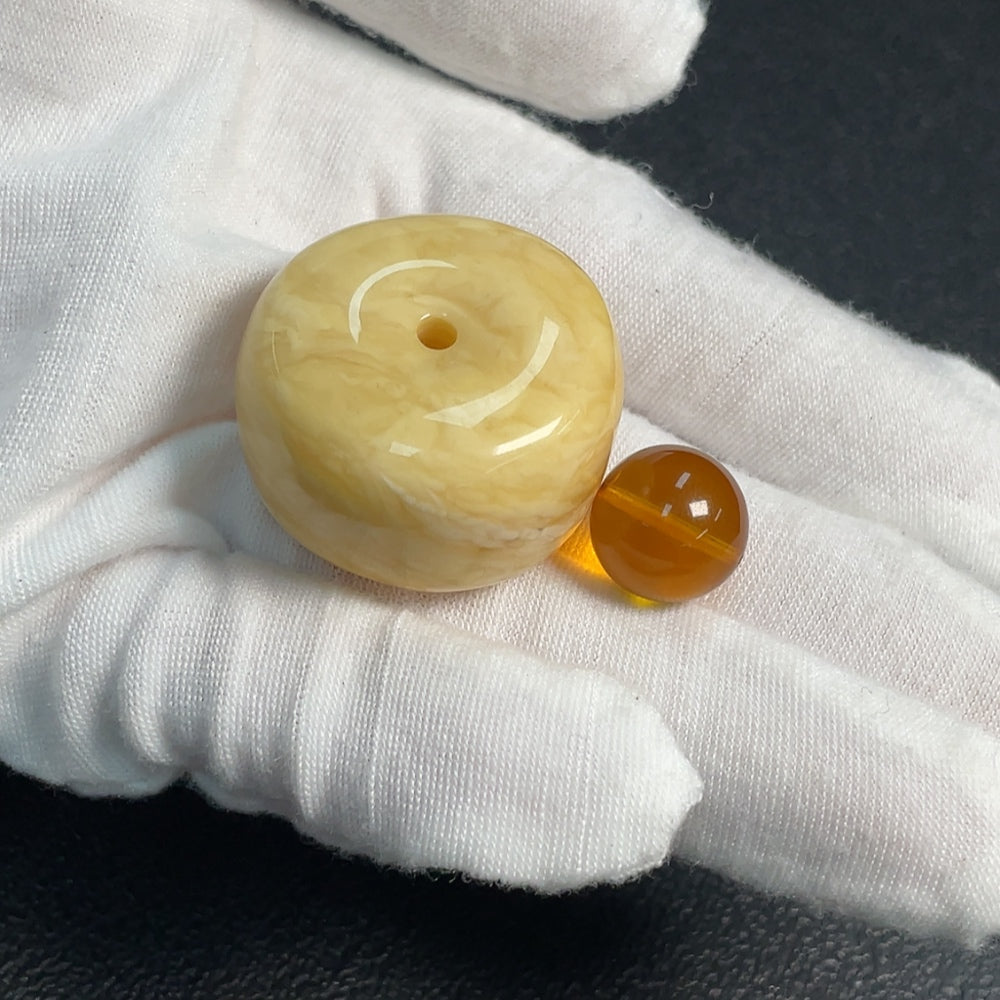 Huiliu certified amber beeswax pendant, natural golden amber jewelry, close-up of pendant showcasing warm, translucent amber piece.
