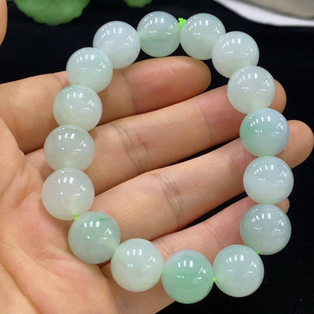 Huiliu certified jadeite bracelet with 12.8mm jade beads, showcasing smooth, polished green jade stones on a delicate string.