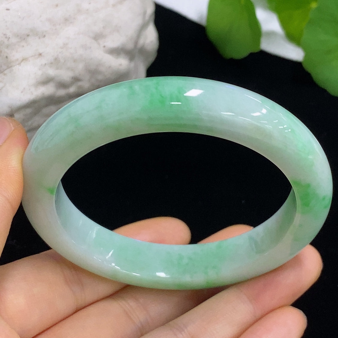 HKHQ jadeite round bangle with a 55.4mm size and 57.1g weight, showcasing smooth, polished jade jewelry.